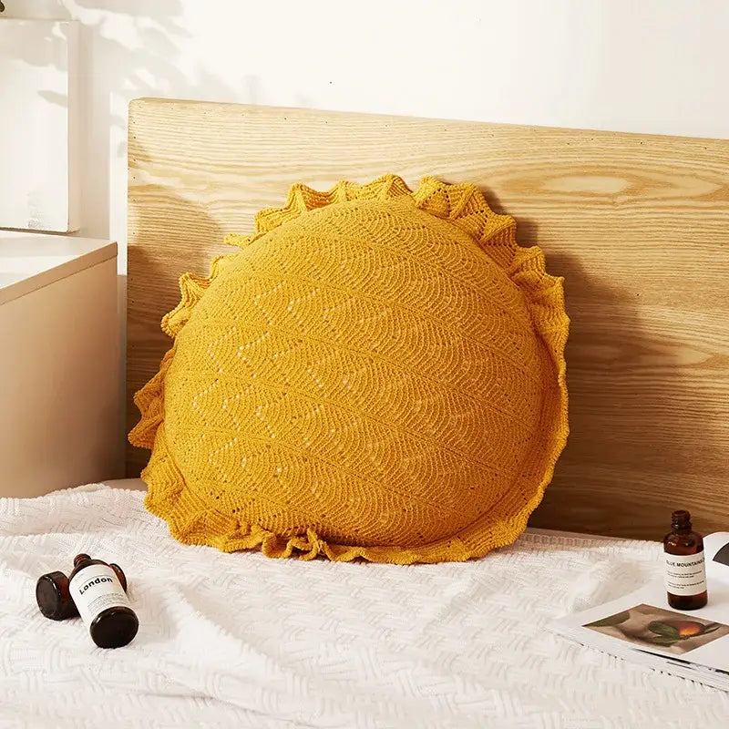 A vibrant mustard-yellow hand-knitted sun-shaped pillow with scalloped edge for home decor and decorbites 3d flowers pillows