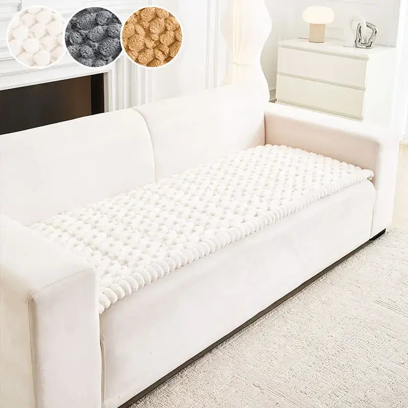 Plush white textured anti slip sofa cover with tufted surface and ribbed edge knitted for living room protection