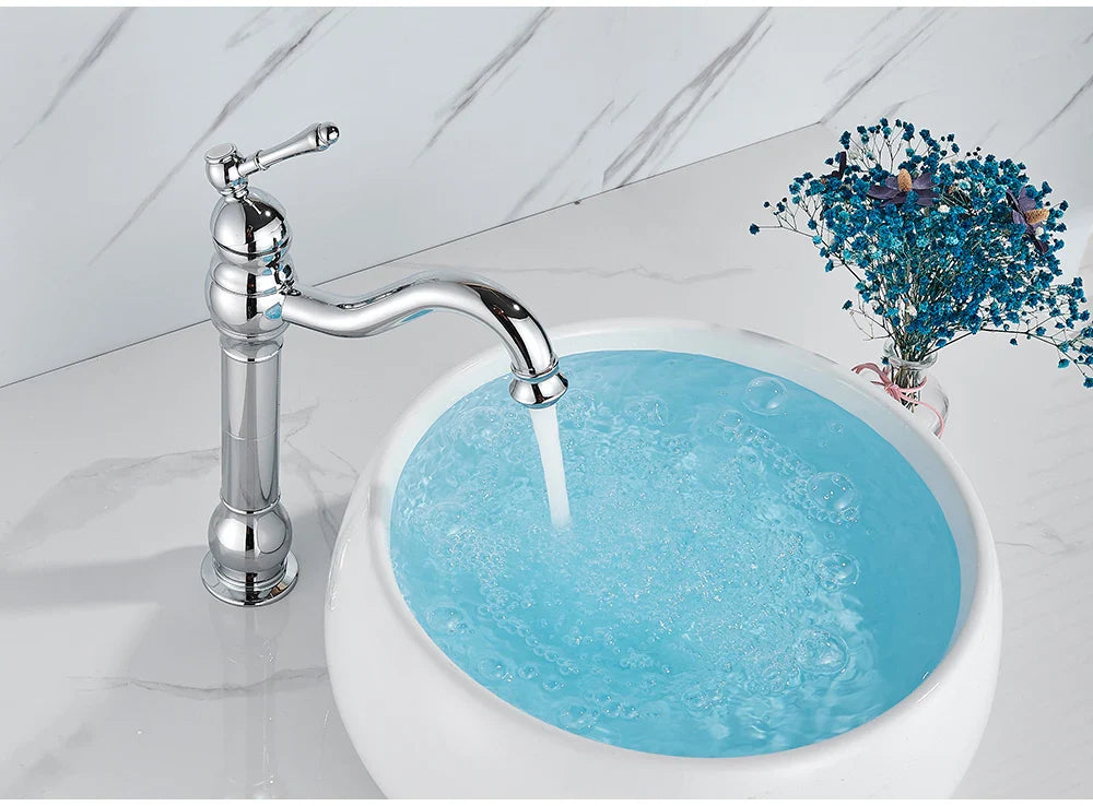 Chrome finished vintage style single hole deck mounted faucet with curved spout and ornate handle housing material metal