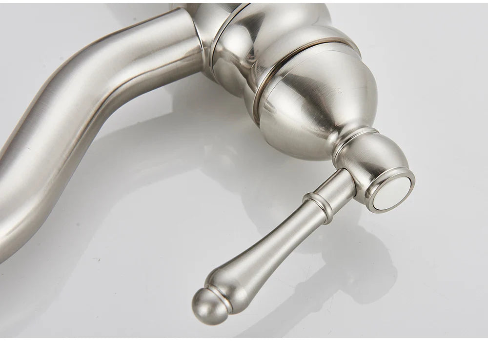 Stainless steel deck mounted single hole kitchen faucet with polished curved spout and ornate handle design housing material