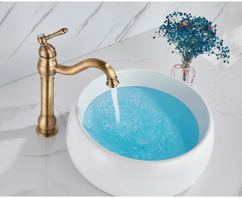 Antique brass deck mounted single hole basin vessel sink faucet with curved spout and brass housing material