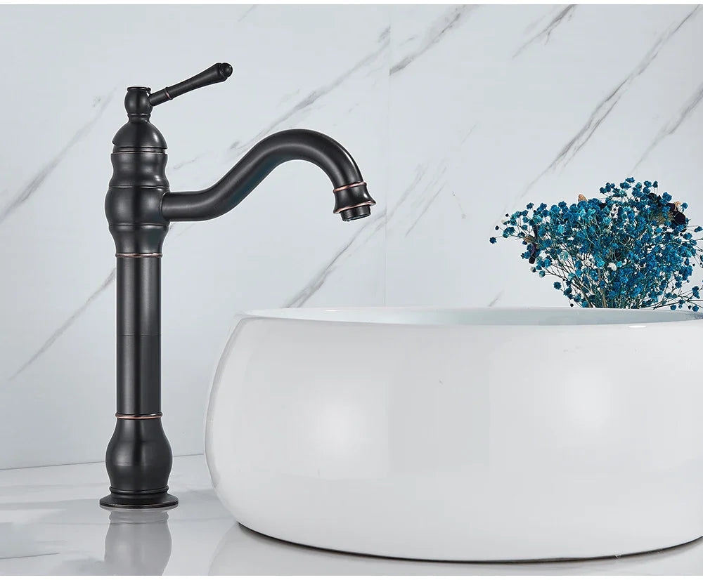 Black matte deck mounted single hole basin faucet with curved spout copper accents and ornate handle housing material brass