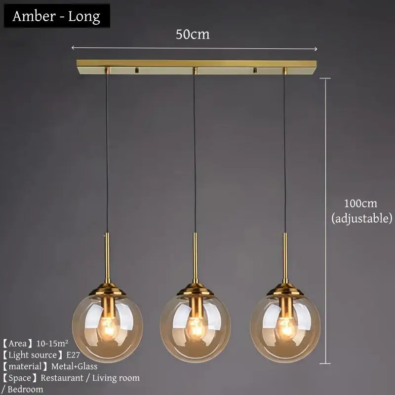 Amber-colored glass pendant light with brass accents and adjustable hanging length in polished steel glass pendant light trio for dining room