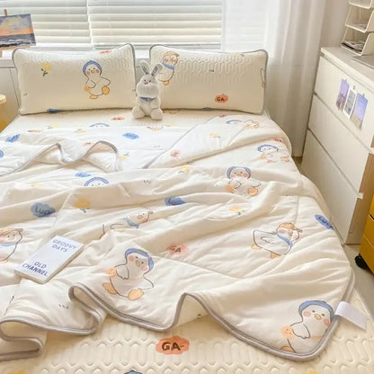 Cream-colored quilted comforter set with playful penguin pattern and soft gray piping for a cool comforter set