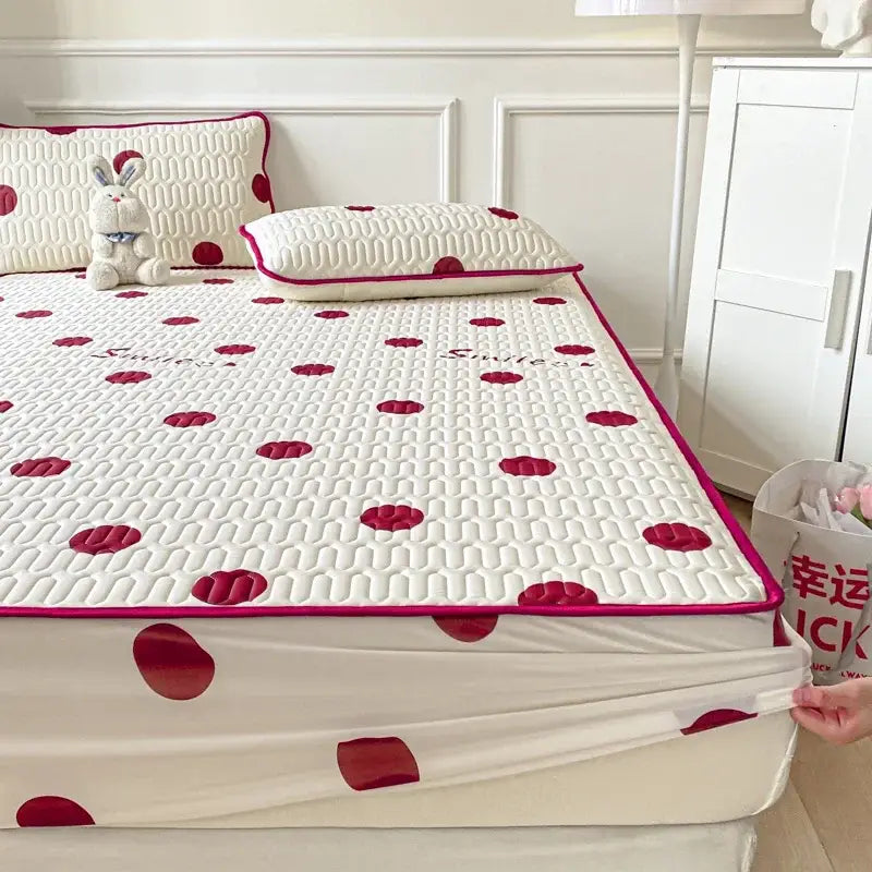 White bed sheet with red polka dots quilted texture and pink trim from polka dot smile cool comforter set