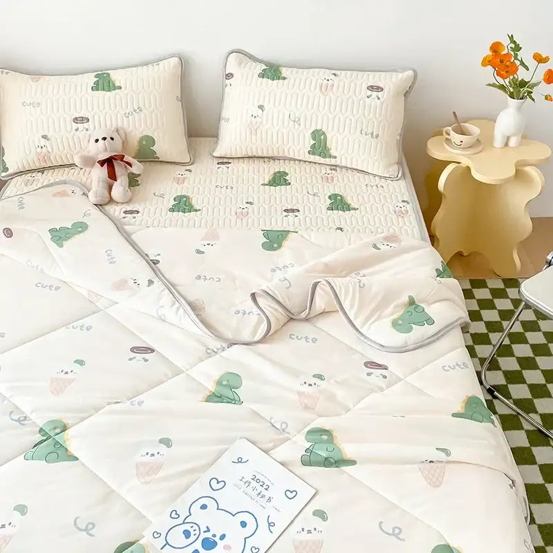 Cream-colored quilted cool comforter set with green dinosaur faces and gray cute text in stitched square panels with border