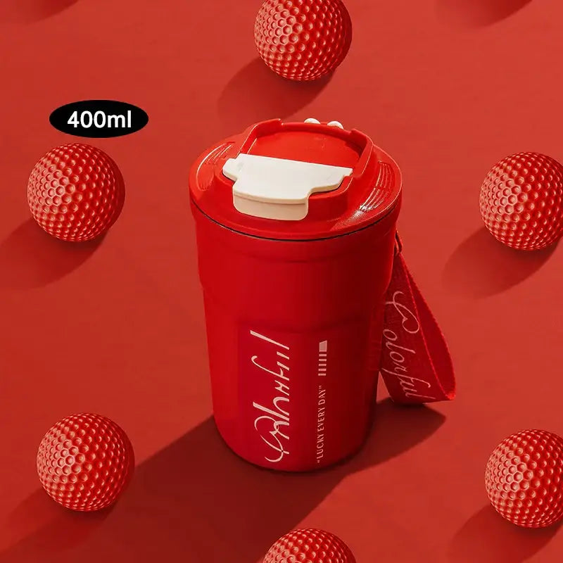 Red 400ml coffee thermos bottle with white flip-top lid and carrying strap featuring cursive text for portable use
