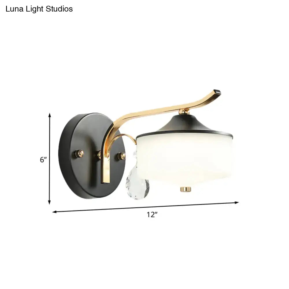 Post modern black and gold wall sconce with opal glass shade and crystal droplet accent for bedroom lighting