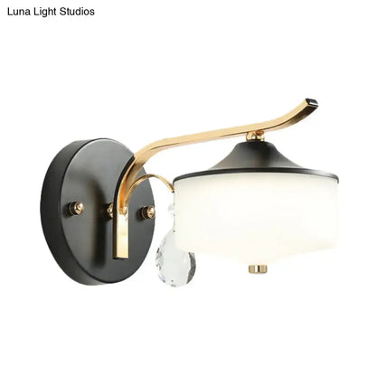 Post modern black and gold wall sconce with opal glass shade and crystal droplet accent for bedroom lighting