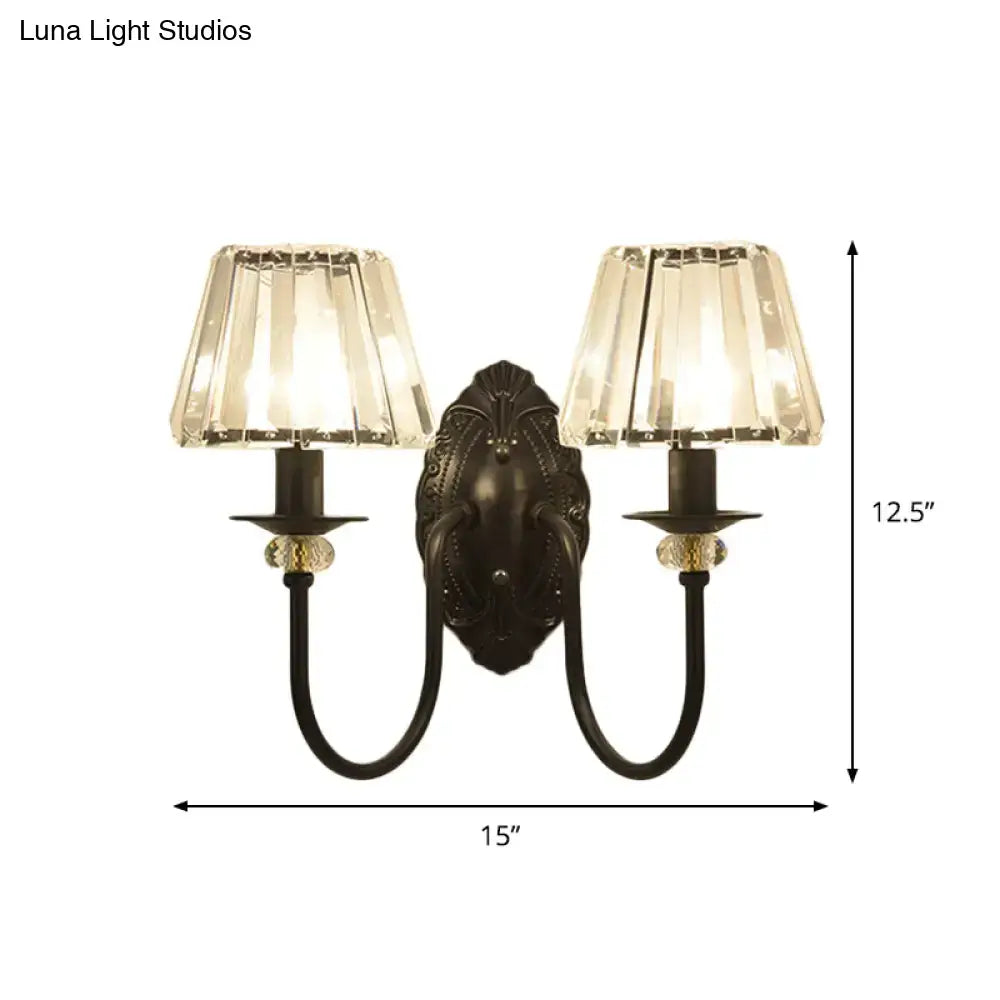 Antique black metal wall sconce with two crystal-encrusted clear crystal shades for bedroom lighting