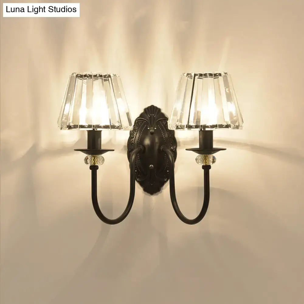 Antique bronze two-light wall sconce with black metal frame clear crystal shade and decorative glass beads for bedroom