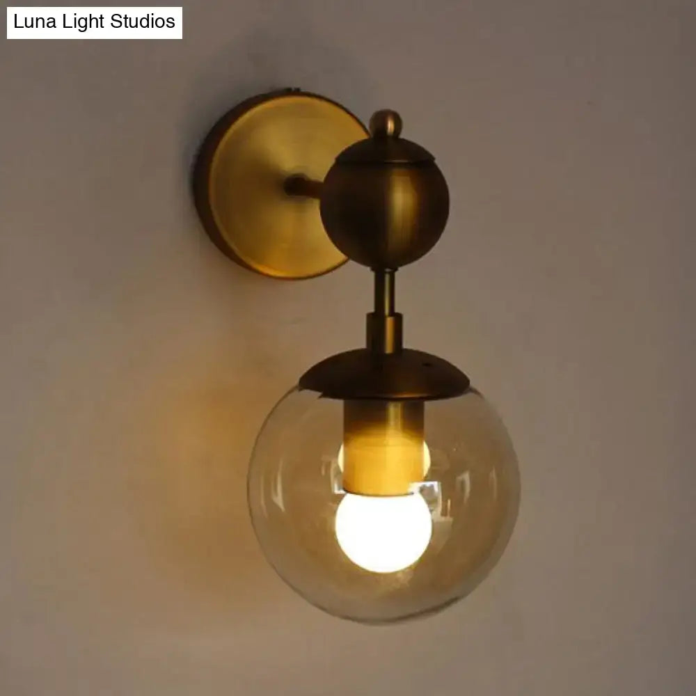 Vintage brass wall light with amber glass globe and illuminated e26 e27 bulb for bedroom sconce lighting