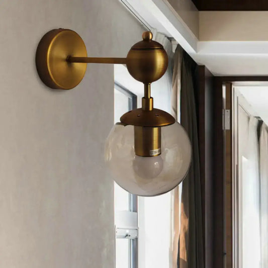 Post modern brass wall light with amber glass globe and decorative ball accents for e26 e27 sockets in bedroom use