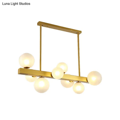 Gold finish DecorBites chandelier with rectangular frame and frosted glass globe light bulbs for dining room post modern design
