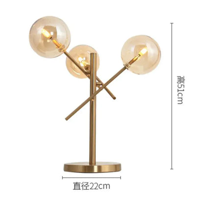 Modern brass floor lamp with three amber glass bubble ball shades in a branching decorbites glass bubble design