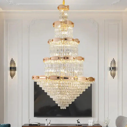A post-modern gold grand hall crystal chandelier with rose gold accents and cascading clear crystals by decorbites grand hall