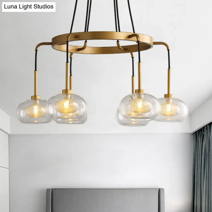 DecorBites™ post-modern island chandelier with clear glass globes, brass-toned finish, black cords, and five LED lights