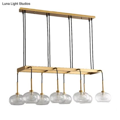 Gold-toned decorbites post-modern rectangular chandelier with six clear glass globe shades and brass accents suspended by black cords