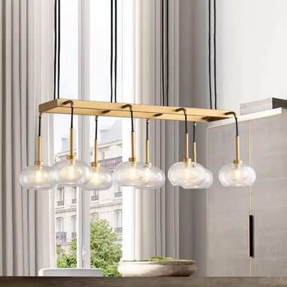 DecorBites post-modern island chandelier with clear glass globe shades brass finish and black cords suspension