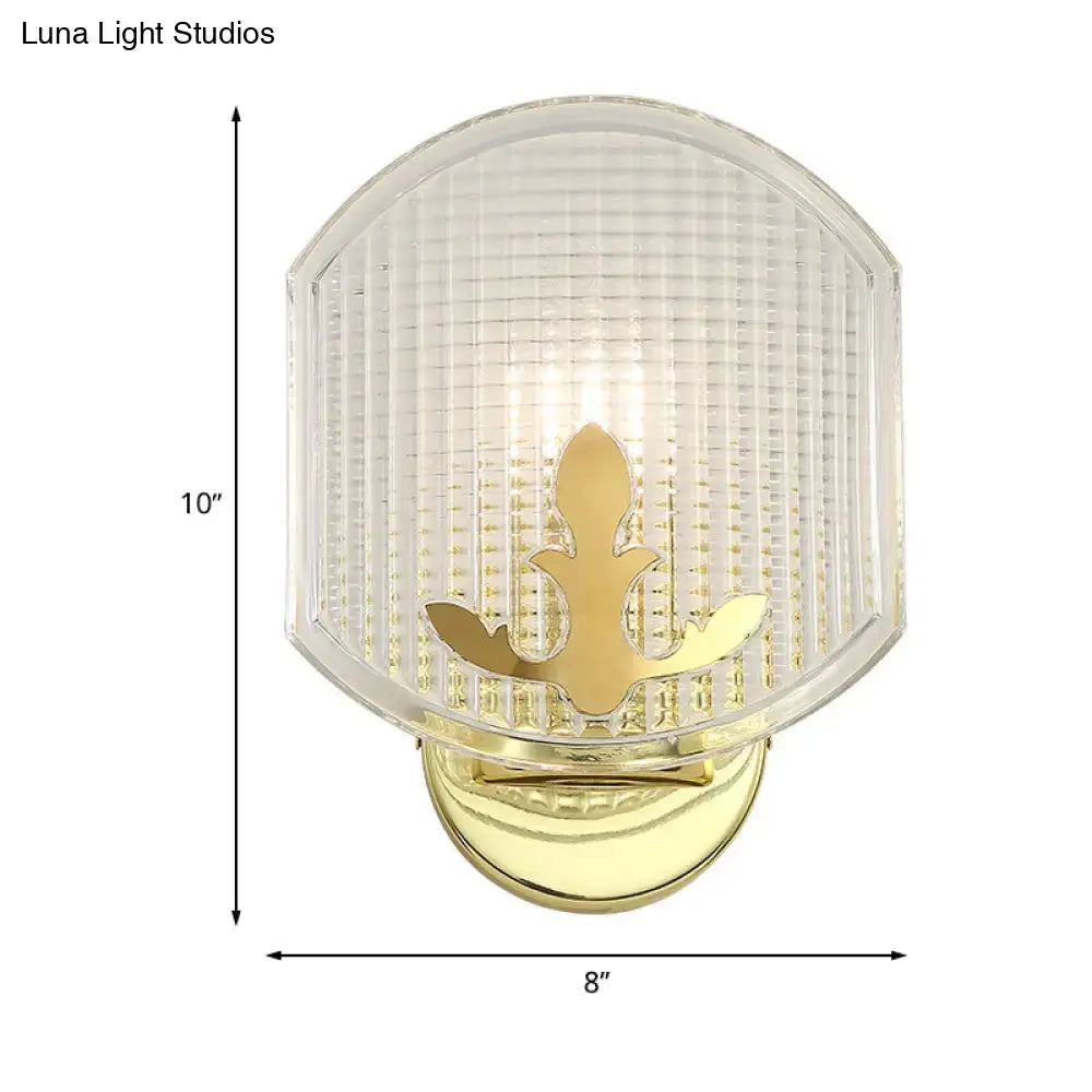 Post-modern gold wall sconce with clear lattice glass shade featuring ornate leaf motif for bedroom lighting