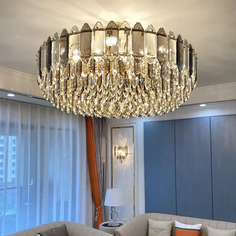 A luxurious gold-toned decorbites crystal chandelier with cascading teardrop crystals for modern living rooms