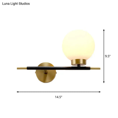 Post-modern white and brass sphere wall sconce with frosted glass globe for bedroom lighting and modern decor