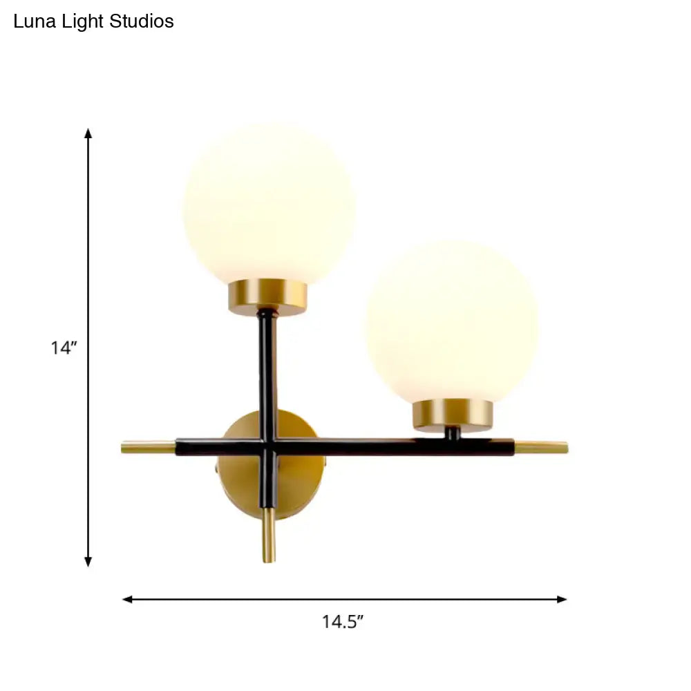 Modern two-light sphere wall sconce with frosted glass globes and black brass finish for bedroom lighting