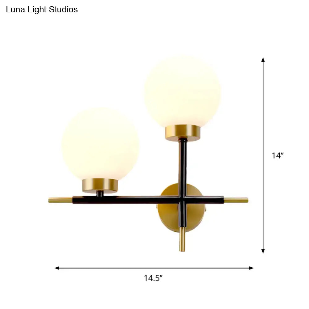 Modern two-light sphere wall sconce with frosted glass globes and black brass finish for bedroom lighting