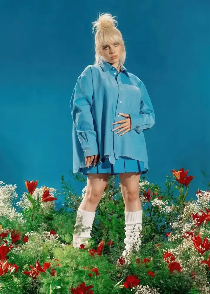 Blue oversized button-up shirt with relaxed fit and asymmetrical hemline paired with b-billies series poster canvas art