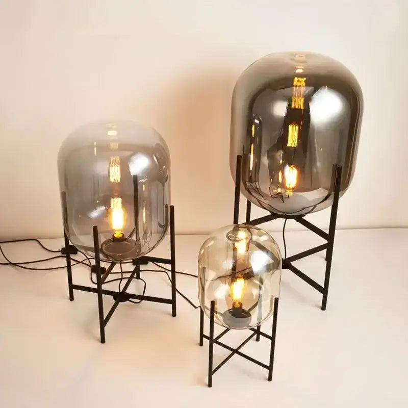 Set of three postmodern amber glass ball floor lamps with black metal stands and warm filament bulbs for decorbites floor lamp