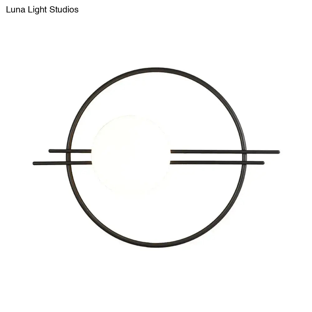 Black brass sconce light featuring a postmodern circular design with white glass and horizontal bars for bedroom use