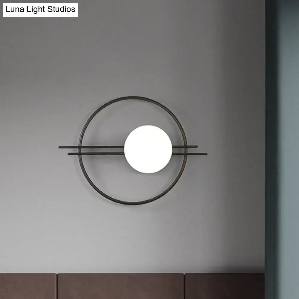 Postmodern black brass sconce light with minimalist circular frame and white glass spherical bedroom lamp