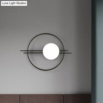 Postmodern black brass sconce light with minimalist circular frame and white glass spherical bedroom lamp