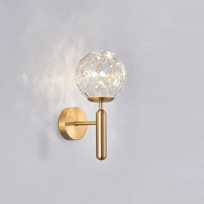 Gold-toned postmodern wall sconce with crackled prismatic glass shade for modern style bedroom lighting