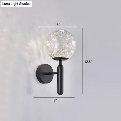 Postmodern black metal wall sconce with crackled prismatic glass shade and warm led fairy lights in modern style