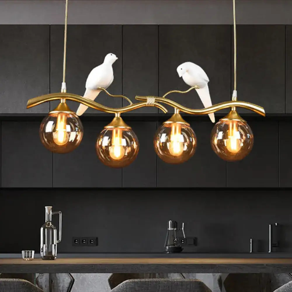 DecorBites postmodern pendant light in black gold with amber ball glass shades and white ceramic dove bird decor