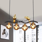 Decorbites™ postmodern iron pendant light with black gold finish, bird design, amber ball glass shade, and four lights