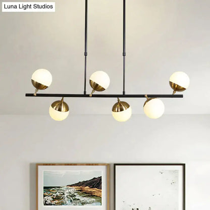Postmodern black and gold island ceiling light with five spherical glass globes and brass-colored metal bases