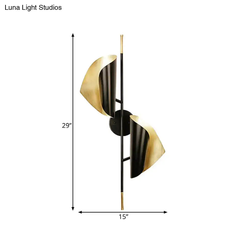 Postmodern black and gold ribbed leaf wall light with two curved metallic shades for staircase lighting