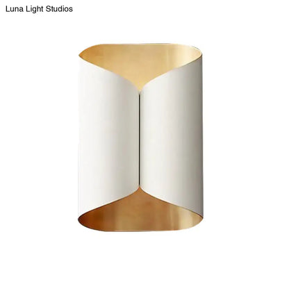 Modern wall lamp with sleek curved white exterior and gold-toned interior lining for stairwell lighting