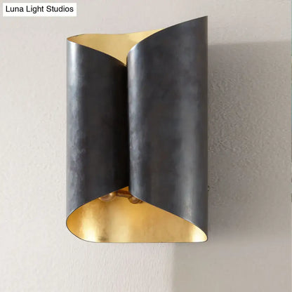 Modern postmodern wall lamp with sleek curved black metal body and contrasting gold interior for stairwell sconce use