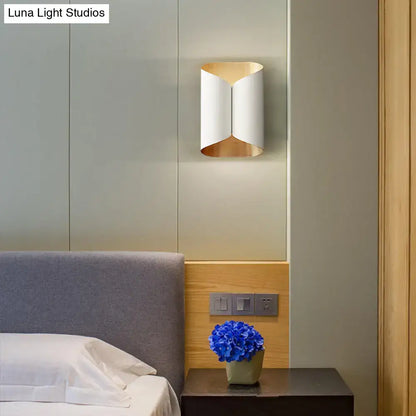 Modern wall lamp with sleek curved white and gold metallic design for postmodern stairwell lighting