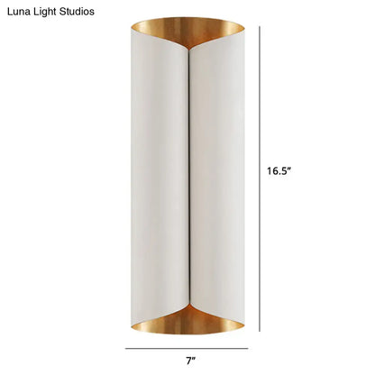 A sleek postmodern wall lamp with white cylindrical body and gold metal accents for stairwell lighting