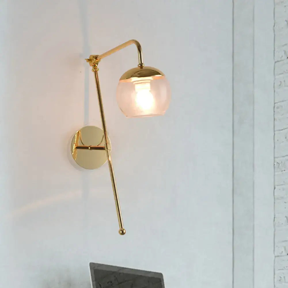 Gold-finished swing arm wall sconce with slender articulated arm and frosted glass globe for bedroom lighting