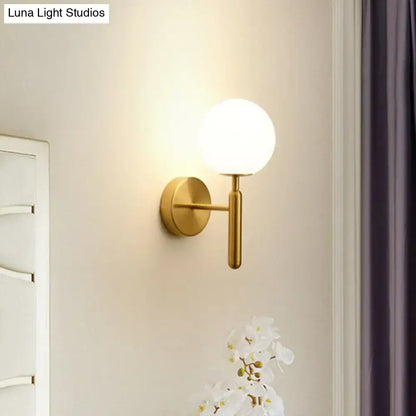 Gold-toned postmodern black gold wall sconce with frosted glass globe for bedroom 110v-120v lighting