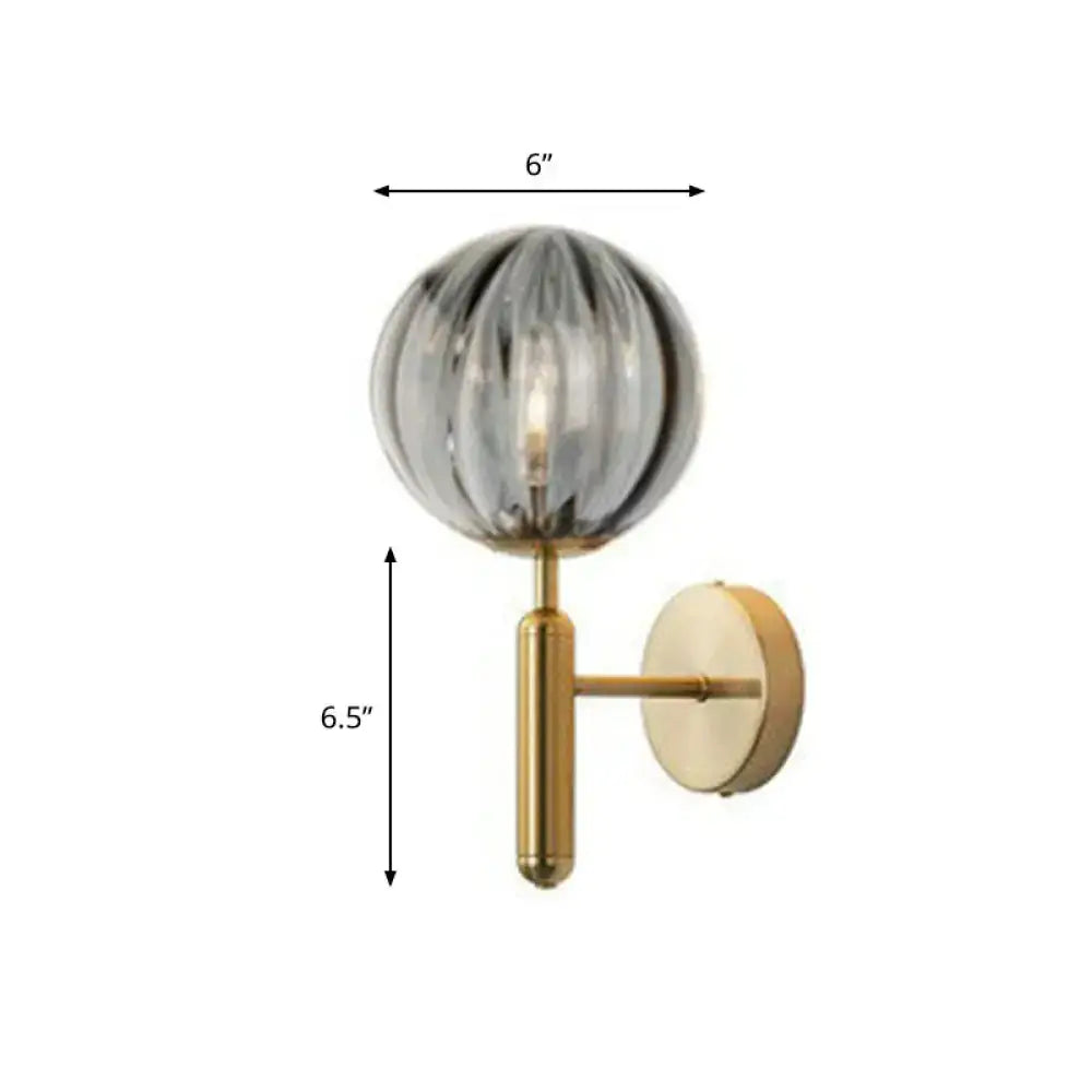 Postmodern black gold wall sconce with spherical ribbed glass globe and brass hardware for 110v-120v lighting
