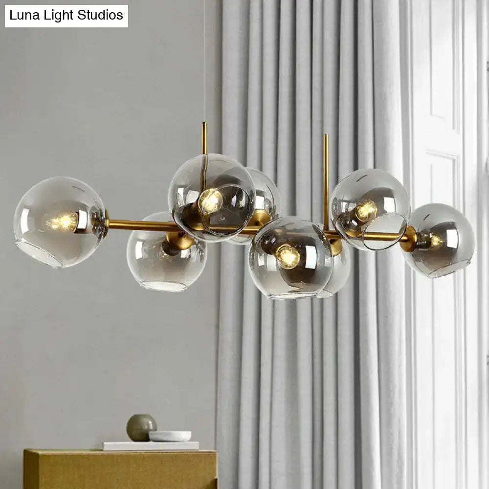 Postmodern black metal 8 head chandelier with modern brass and clear smoke grey glass globe shades for dining room