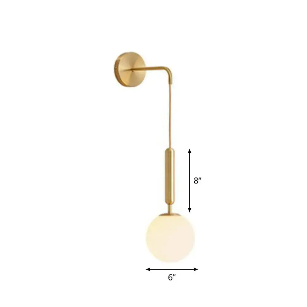 Gold-toned wall lamp with sleek curved arm and frosted glass globe shade for modern bedroom lighting
