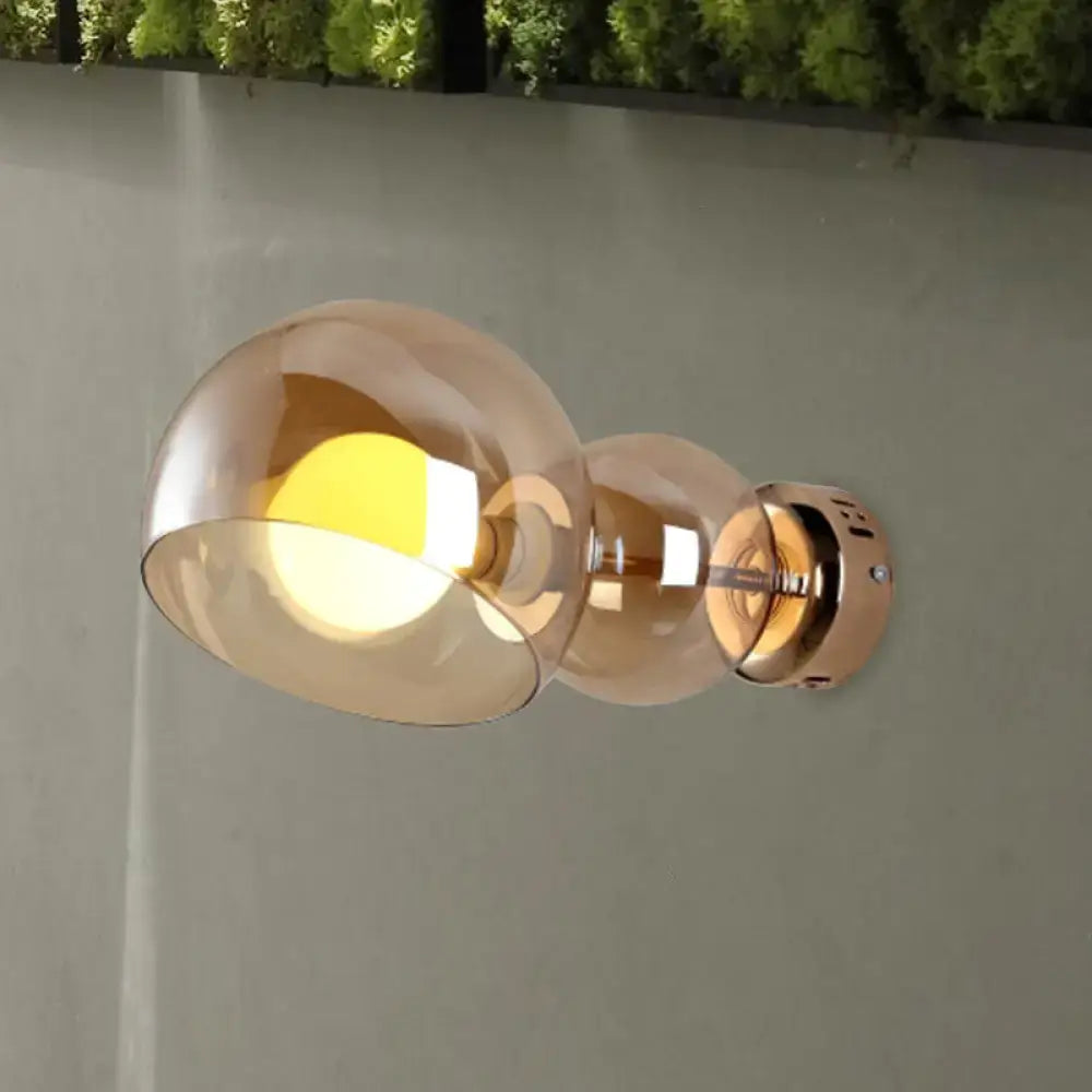 Modern wall lamp bedroom sconce with amber glass shade and brushed brass finish featuring two amber glass globes