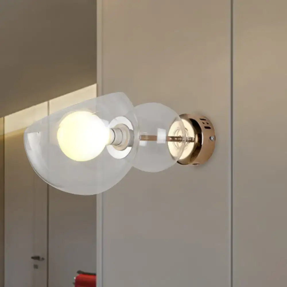 Modern wall lamp with amber glass shade and brass metal base ideal for bedroom sconce lighting